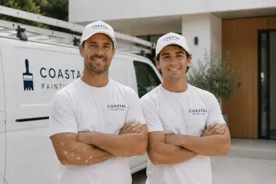 Coastal Painting's owner-operators in their branded uniforms beside the company van