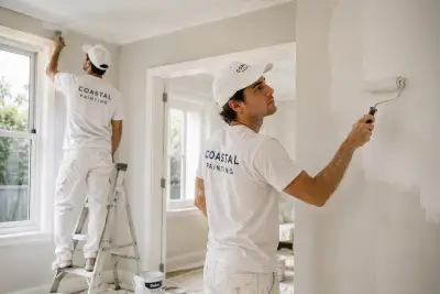 The Coastal Painting crew rolling fresh paint onto interior walls